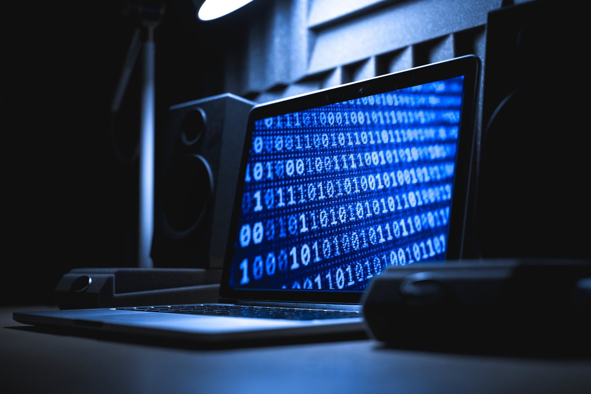 black and gray speaker beside black computer mouse